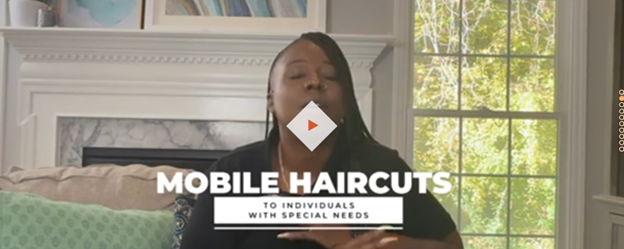 Video thumbnail showing a person speaking indoors, with on-screen text reading ‘Mobile Haircuts to Individuals with Special Needs’ and a play button centered on the image.